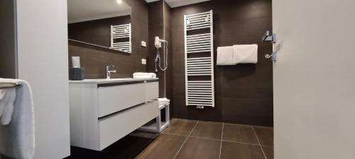 a bathroom with a sink and a mirror at RivAppartamenti in Riva del Garda