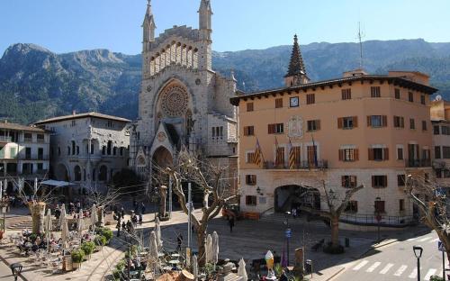 a large building with a church in a city at CALM HOUSE in Sóller