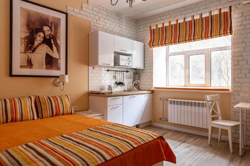 a small bedroom with a bed and a kitchen at Призрак оперы in Saint Petersburg
