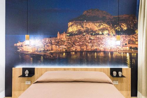 a bedroom with a wall mural of a city at Incao Holiday Il Moro House in Cefalù