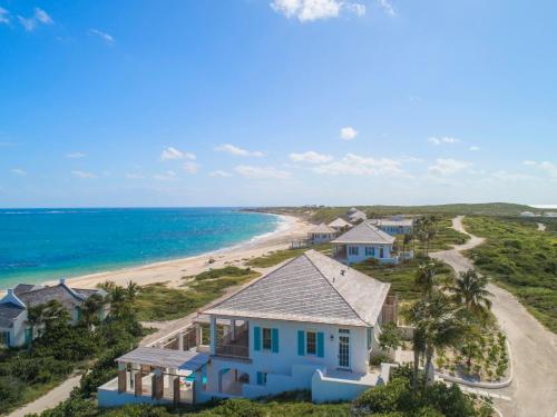 an aerial view of a house and the beach at Ambergris Cay - Private Island All-Inclusive in Big Ambergris Cay