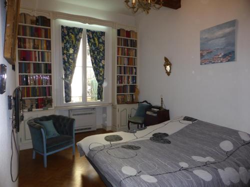 a bedroom with a bed and a window and book shelves at Michelet in Collioure