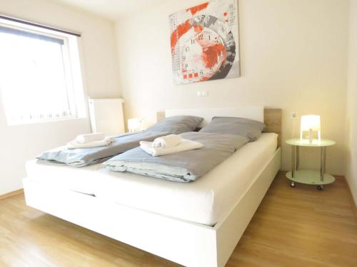 a large white bed in a room with a window at Böhmerwald Pur2 mit Sauna in Klaffer am Hochficht