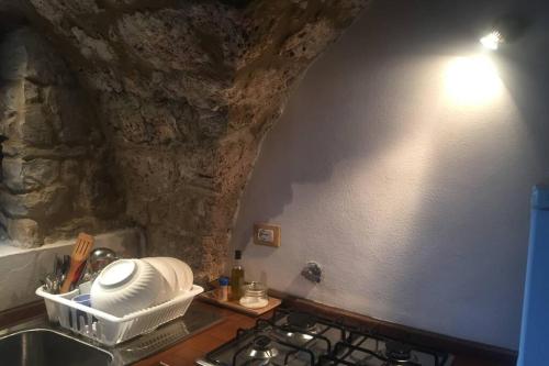 a kitchen with a sink and a stone wall at Casa Majella di Casale Corneto in Bomba