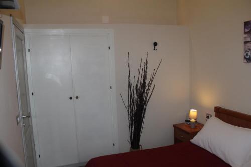 a bedroom with a bed and a closet and a lamp at Hotel Il Casale in Trevignano Romano