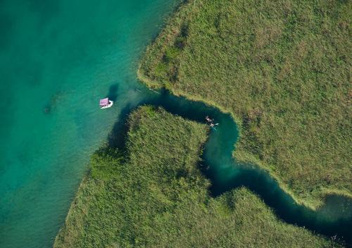 an aerial view of a boat in a river at Alpe Adria Apartments - Top 11 by S4Y in Oberaichwald