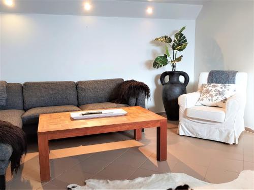 a living room with a couch and a coffee table at Guesthouse Vatnsholt in Vatnsholt