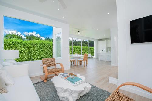 a living room with a couch and a tv and a table at Garden Grove in Saint James