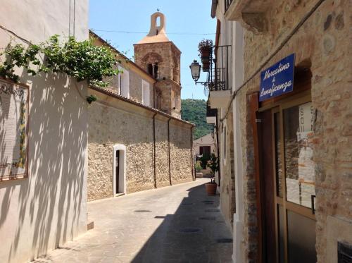 an alley in an old town with a church at Bungalows by B&B Villa Sveva in Rocca Imperiale