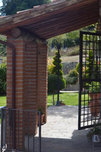 an entrance to a brick building with a gate at Il Borghetto di Carra in Talla