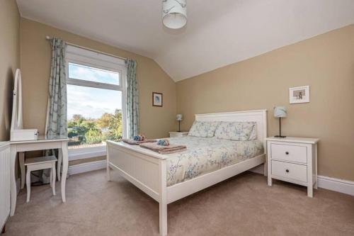 a bedroom with a bed and a window and a desk at Cliff Top, Hornsea, Close to Sea in Hornsea