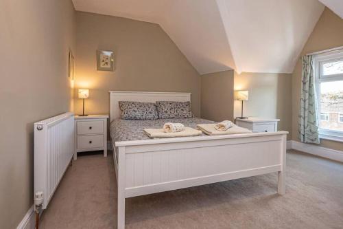 a bedroom with a large white bed with two night stands at Cliff Top, Hornsea, Close to Sea in Hornsea