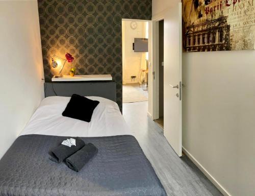 1 dormitorio con 1 cama con 2 almohadas en SLEEP INN - Industrial Flat Citycenter, en Amberes