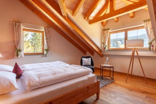 a bedroom with a bed in a room with wooden ceilings at Hotel Natur-Landhaus Krone in Maierhöfen