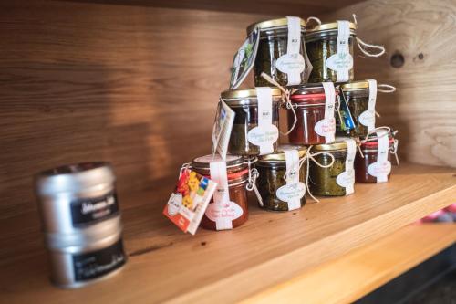 a group of canning jars on a table with a coffee at Hotel Natur-Landhaus Krone in Maierhöfen