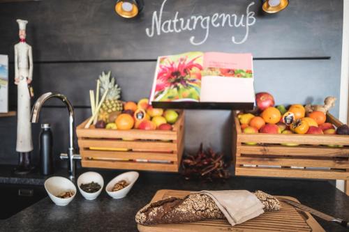 a kitchen counter with two baskets of fruit on it at Hotel Natur-Landhaus Krone in Maierhöfen