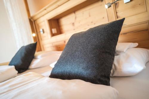 a bedroom with three pillows on a bed at Hotel Natur-Landhaus Krone in Maierhöfen