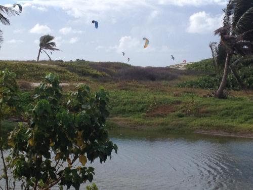 a group of kites flying over a body of water at Sea Shells Villa in Christ Church