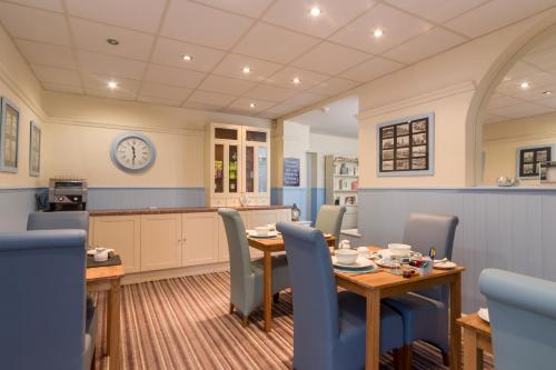 a kitchen and dining room with a table and chairs at The Fountaindale Skegness in Skegness