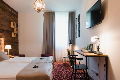 Postel nebo postele na pokoji v ubytování Hotel Podklasztorze