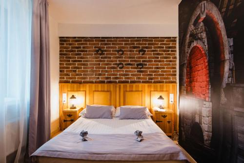 Postel nebo postele na pokoji v ubytování Hotel Podklasztorze