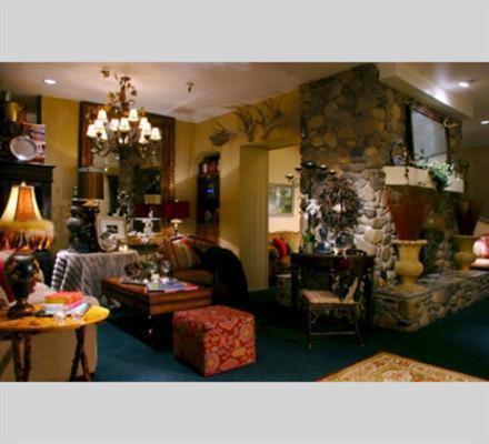 a living room with a couch and a stone fireplace at GetAways at the Lodge at Kingsbury Crossing in Stateline