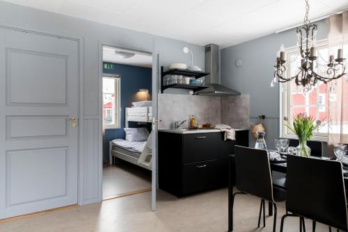 a kitchen and dining room with a table and a dining room at Stockeboda Gård in Gärsnäs