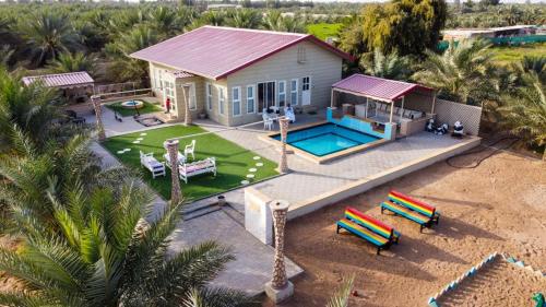 an aerial view of a house with a swimming pool at Al Reef Rest House in Al Khārī