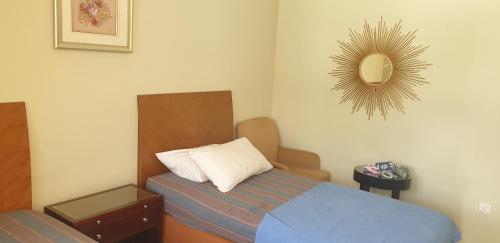 a small bedroom with a bed and a mirror at MRI Residence - Homestay in Sg Buloh with Swimming Pool - No Pork&Alcohol Allowed in Bandar Puncak Alam