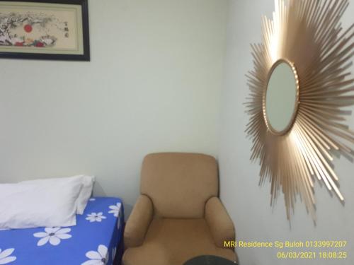 a room with a chair and a mirror on the wall at MRI Residence - Homestay in Sg Buloh with Swimming Pool - No Pork&Alcohol Allowed in Bandar Puncak Alam