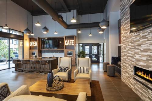 a living room with a fireplace and a bar at Luxury Condos at Anton Menlo w Pool & Amenities in Menlo Park