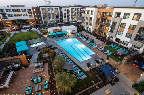 an overhead view of a pool in a city with buildings at Luxury Condos at Anton Menlo w Pool & Amenities in Menlo Park
