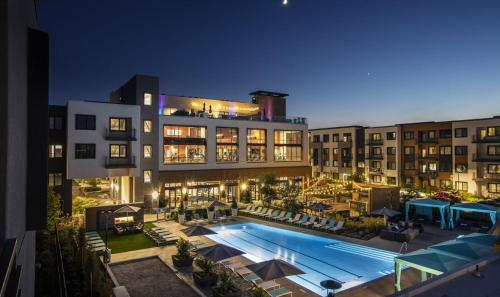 a hotel with a swimming pool in front of a building at Luxury Condos at Anton Menlo w Pool & Amenities in Menlo Park