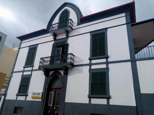 a building with a clock on the front of it at Pensao Residencial Mirasol in Funchal