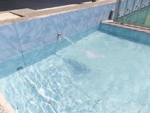 a pool of blue water with a water hose at MRI Residence - Homestay in Sg Buloh with Swimming Pool - No Pork&Alcohol Allowed in Bandar Puncak Alam