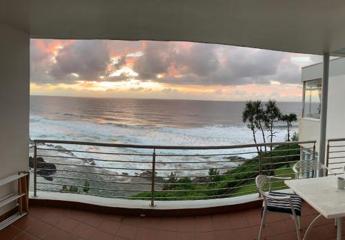 a balcony with a view of the ocean at Chakas Cove in Ballito