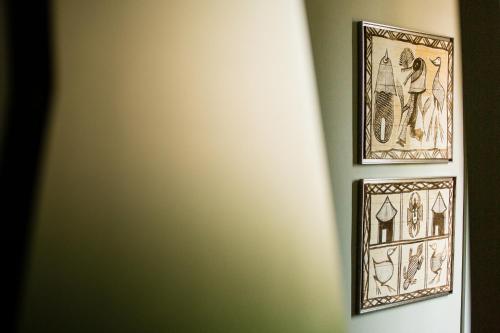 two framed pictures hanging on a wall at Amadores Beach Apartments in Mogán