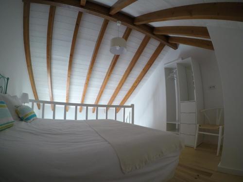 a bedroom with a bed with a wooden ceiling at Recantus Comporta in Comporta