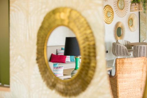 a mirror reflection of a living room with a couch at Amadores Beach Apartments in Mogán