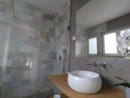 a bathroom with a white sink and a shower at Recantus Comporta in Comporta
