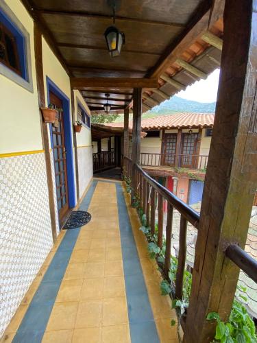 an external walkway of a house with a balcony at Vila Pequeá Pousada Ilhabela in Ilhabela