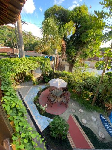 an overhead view of a patio with a table and umbrella at Vila Pequeá Pousada Ilhabela in Ilhabela
