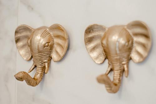two gold elephant ear hooks hanging on a wall at Smarthotel Völkermarkt in Völkermarkt