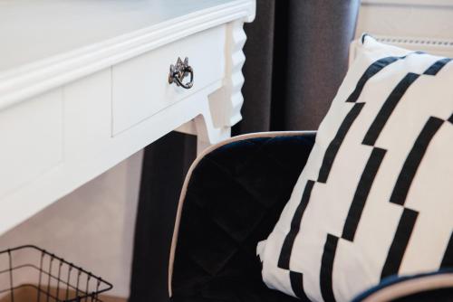 a black and white pillow next to a white fireplace at Smarthotel Völkermarkt in Völkermarkt