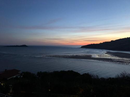a view of the ocean at sunset at Mundaka Vista Mar L-BI-52 in Mundaka