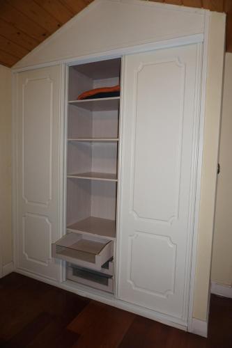 a white cabinet with a door in a room at Mundaka Vista Mar L-BI-52 in Mundaka