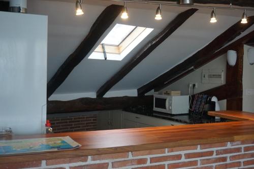 a kitchen with a skylight in a loft at ATICO TORRONTERO in Mundaka