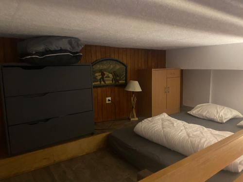 a bedroom with a large bed and a dresser at Résidence Belle Hutte 2 in La Bresse