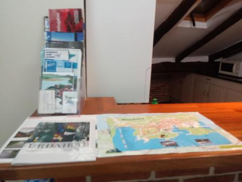 a table with a map and a book on it at ATICO TORRONTERO in Mundaka
