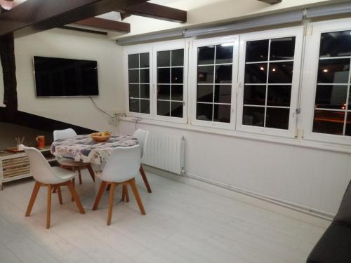 a dining room with a table and chairs at ATICO TORRONTERO in Mundaka